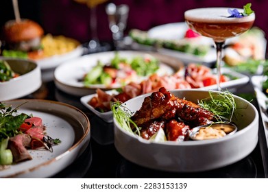 table full of delicious food in plates in restaurant - Shutterstock ID 2283153139