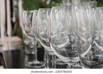 Table full of empty wine glasses at a summer wedding. Festive wedding concept