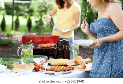 Table Full Of Food And Wondering Woman