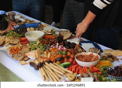 A table full of fresh vegetables, fruit, cheese and biscuits