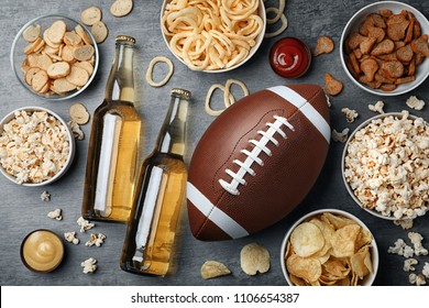 Table Full Of Tasty Snacks And Beer Prepared For Watching American Football On TV, Top View