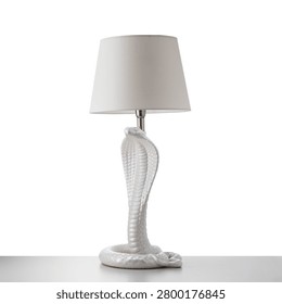 table lamp with white ceramic base in the shape of a cobra.