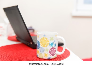 Table with laptop and cup