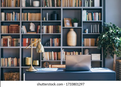 Table with laptop in home office interior. - Shutterstock ID 1733801297
