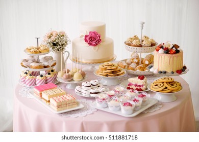 Table with loads of cakes, cupcakes, cookies and cakepops. - Powered by Shutterstock