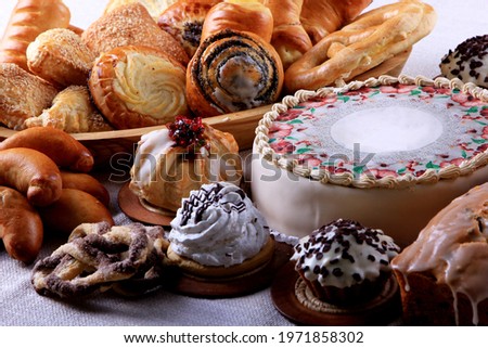 
Table with loads of cakes, cupcakes and pies. cake selection on white fabrics. Copy space 