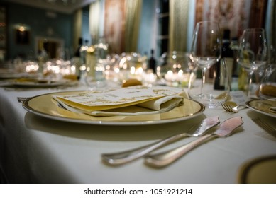 table in a luxury restaurant, set for a gala dinner, on the table various candles