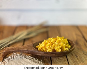 Table Made Of Oak Boards You Can See The Jars On Them There Is A Bunch Of Corn And A Wooden Spoon With Noodles A Wall Made Of Pine Boards Painted White