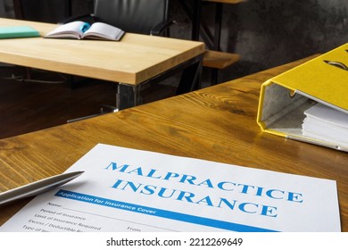 Table With Malpractice Insurance Application On It.