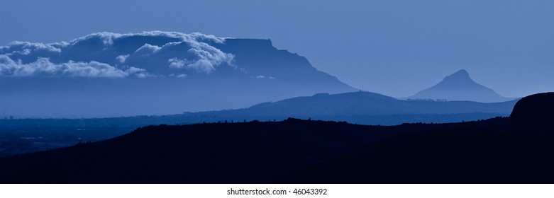 Table Mountain dressed in clouds in cool evening colours
