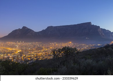 Table Mountain at dusk with city lights and blue sky - Shutterstock ID 233339629