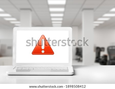 Table With a Notebook Computer Screen That Displays a Symbol which Messages: Caution, Attention, Warning, Error, Halt