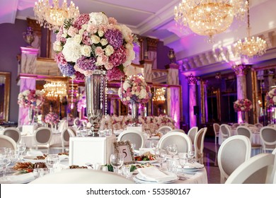 Table number 5 decorated with pink and violet hydrangeas and served with sparkling glassware