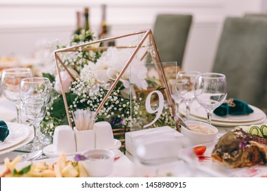 table number nine. wedding table. cured table. decor. wedding details. Round Banquet table served. Interior of restaurant for wedding dinner, ready for guests. Dishes, wine glasses and napkins.