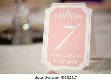 A Table Number Plate With Wedding Hashtag