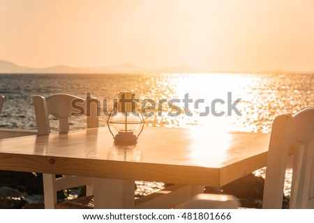Table on the beach at sunset in Naxos, Greece