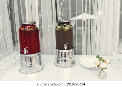 A table on which there are cans of lemonade. Jars with various lemonade on the table. A party.