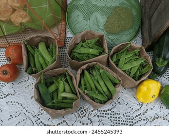 A table outside in the summer full of green peas and vegetables at a farmer's market - Powered by Shutterstock