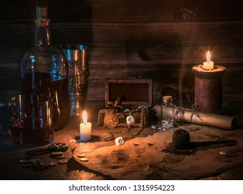 table of a pirate, rum or whisky in a bottle and glass, vintage map, candles and treasures, pipe for smoking