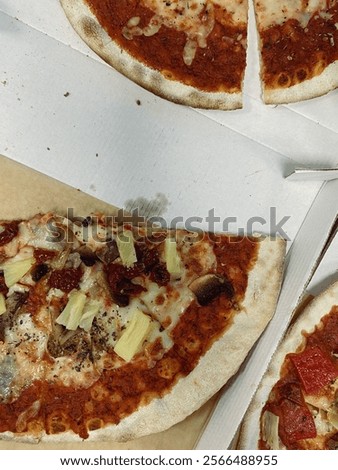 Table with pizza slice in the opened box