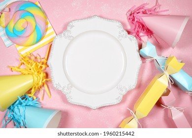 Table place setting plate. Birthday and parties theme SVG craft product flat lay mock up styled stock photo. Styled with pink, blue and yellow party hats and bon bons on a textured pink background. - Shutterstock ID 1960215442