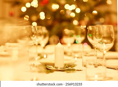 Table Prepared For A Family Celebration Dinner With A Tradtional Christmas Tree In The Background