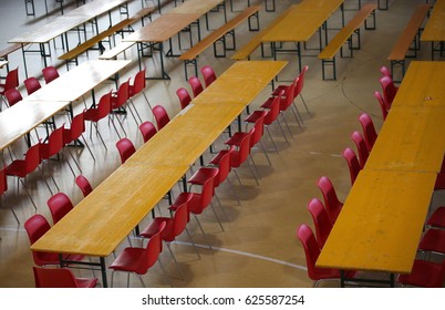 Table With Red Chairs In A Wide Lunch Room In A School