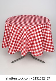 A table with a red checkered tablecloth on a white isolated background