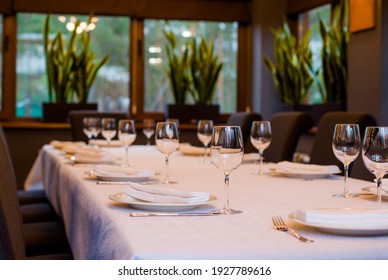 Table In A Restaurant With Cutlery Fork Knife White Tablecloth Glasses For Wine And Water