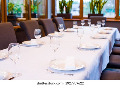 Table In A Restaurant With Cutlery Fork Knife White Tablecloth Glasses For Wine And Water