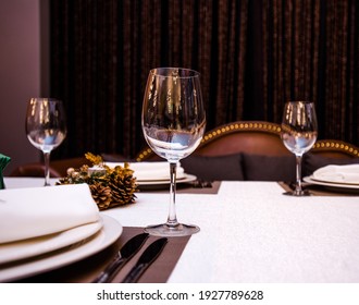 Table In A Restaurant With Cutlery Fork Knife White Tablecloth Glasses For Wine And Water