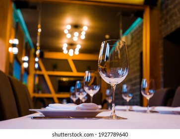 Table In A Restaurant With Cutlery Fork Knife White Tablecloth Glasses For Wine And Water