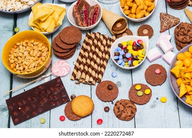 Table Of Salty And Sweet Snacks. Large Group Of Unhealthy Food