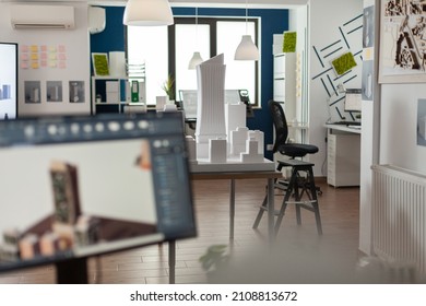 Table with scale foam model of skyscraper in empty architectural office used for urban development and architecture design. Workstation with 3D render blueprints of real estate buildings. - Powered by Shutterstock - Get 15% off with code: PIKWIZARD15
