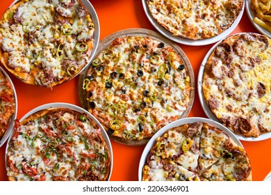 Table scene of assorted take out or delivery foods. Pizza, hamburgers, Doner, fried chicken and sides. Top down view on a table.