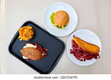 Table Scene Of Assorted Take Out Or Delivery Foods. Pizza, Pide, Hamburgers, Doner, Fried Chicken And Sides. Top Down View On A Table.