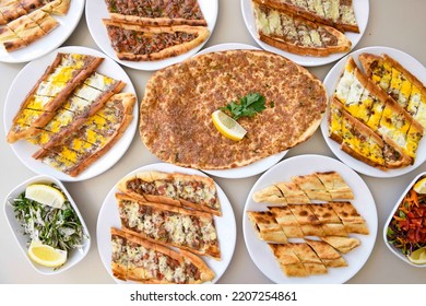 Table scene of assorted take out or delivery foods. Pizza, hamburgers, Doner, fried chicken and sides. Top down view on a table.