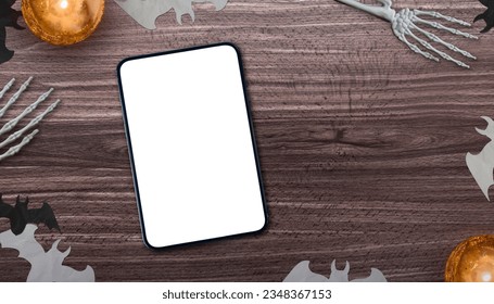 table seen from above with a smart tablet and halloween objects - Powered by Shutterstock