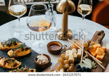 A table served for a dinner with different kinds of appetizers and wine in a bar or restaurant.