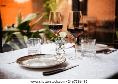 Table served for dinner with red wine in a restaurant.