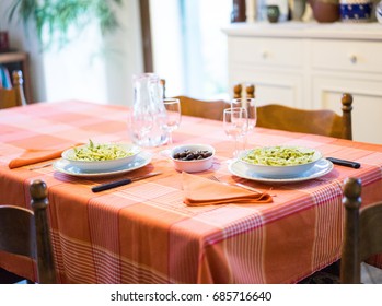 Table served fir two people with pasta and beans. 