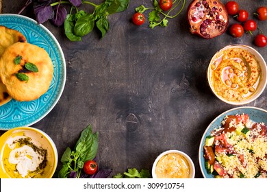 Table Served With Middle Eastern Traditional Vegetarian Dishes. Hummus, Tahini, Pitta, Couscous Salad And Buttermilk Dip With Olive Oil. Dinner Party