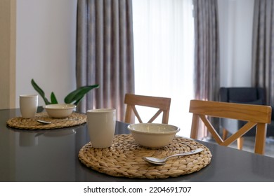 Table Set For Breakfast For Two People With Cutlery Set In A Lighted Space