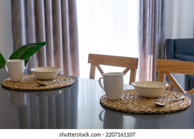 Table Set For Breakfast For Two People With Cutlery Set In A Lighted Space