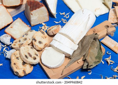 table set with a cheese board and different kinds of bread