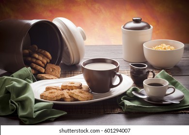 Table set up for continental breakfast: coffee, milk, tea, cookies, corn flakes. - Powered by Shutterstock