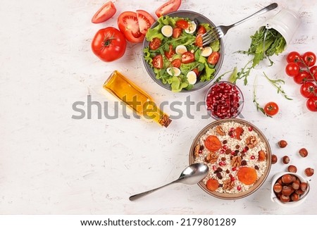 The table is set. Health food. Proper nutrition. Salad, oatmeal and fruits, top view from copy space