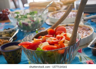 A Table Set For A House Party With Snacks And Salads