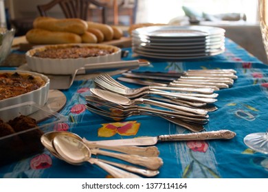 A Table Set For A House Party With Snacks And Salads