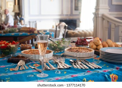 A Table Set For A House Party With Snacks And Salads